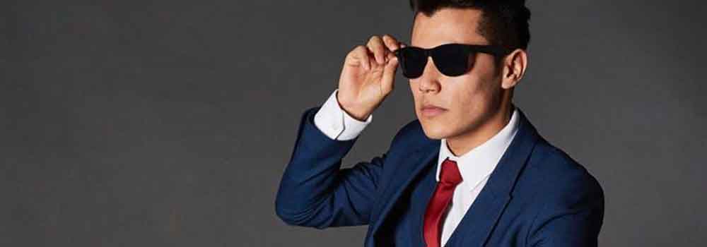 the-modern-gentleman-stylish-man-in-blue-suit-with-red-tie-wearing-sunglasses