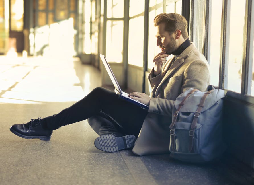 the-modern-gentleman-sitting-in-a-suit-working-on-laptop