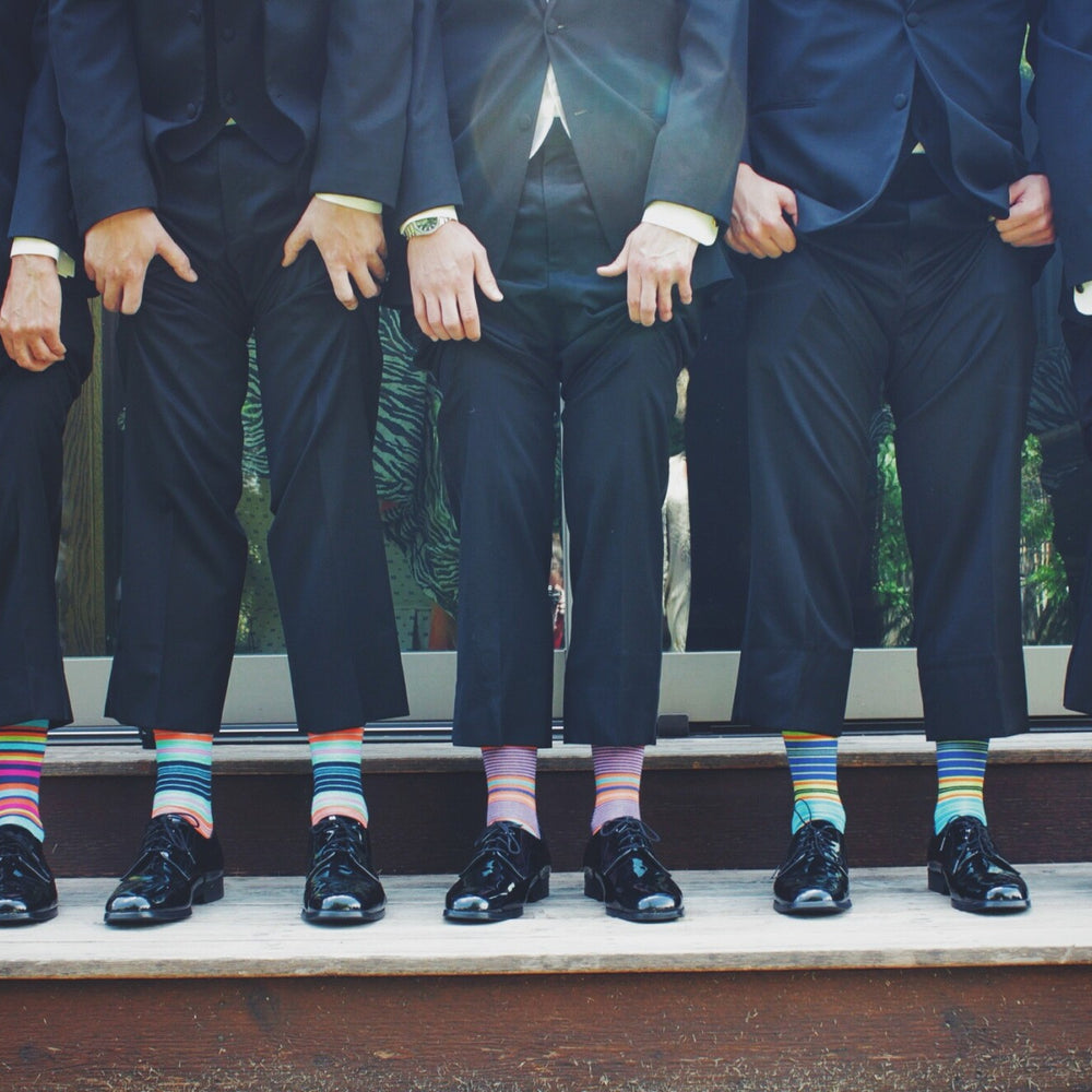 the-modern-gentleman-men-lifting-trousers-to-show-colourful-socks