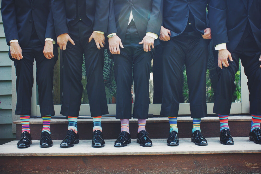 the-modern-gentleman-men-lifting-trousers-to-show-colourful-socks