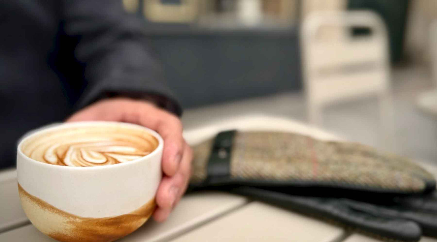 Espresso and notebook on a quiet Paris café table representing slow living and mindful daily rituals
