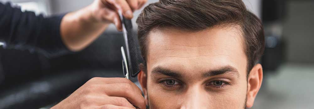 the-modern-gentleman-Skillful-hairdresser-cutting-mans-hair