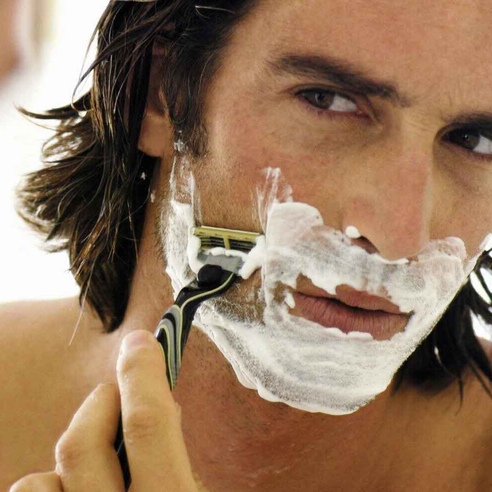 the-modern-gentleman-man-shaving-in-mirror