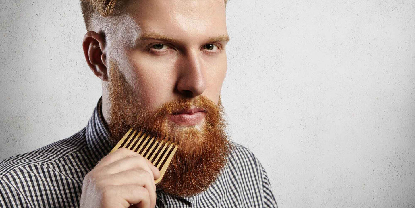 the-modern-gentleman-portrait-of-young-attractive-man-combing-his-beard