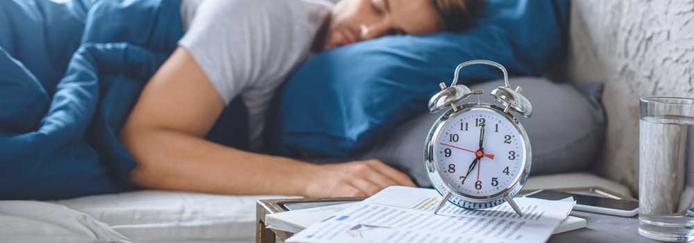 the-modern-gentleman-selective-focus-alarm-clock-sleeping-man-bed